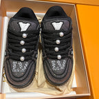 Black Louis Vuitton lace-up sneakers showing lace wrap and pearl stud accents