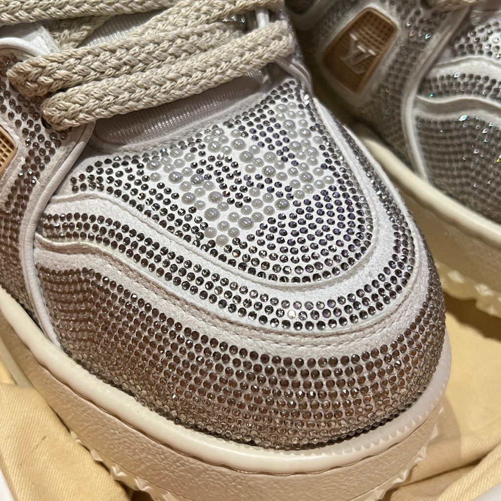 Close-up of Louis Vuitton trainer toe and side, silver studded mesh with lace detail