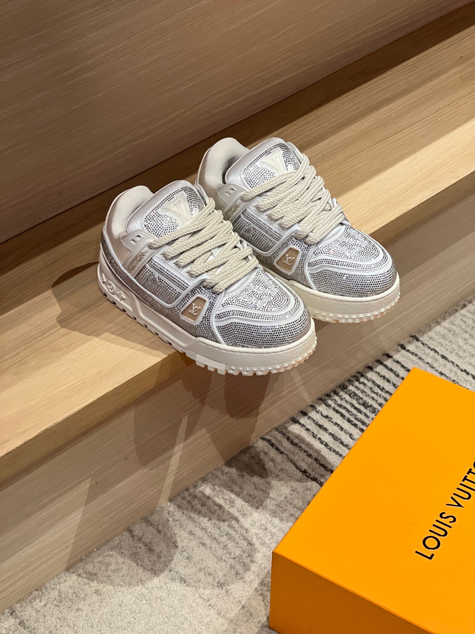Pair of silver Louis Vuitton trainer sneakers with lace-up knit upper and white rubber sole