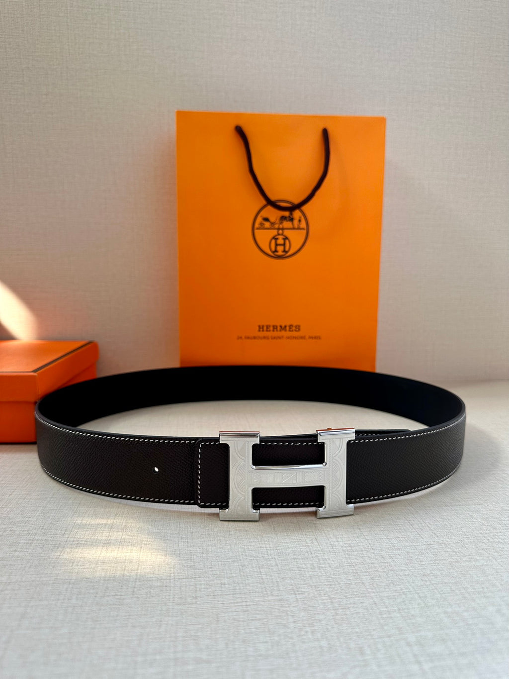 Hermes leather belt, dark strap with centered silver buckle and end prong