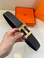 Hermes leather belt, dark with textured finish and silver buckle, end holes visible