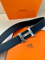 Hermes belt close view, dark navy textured leather with silver square buckle