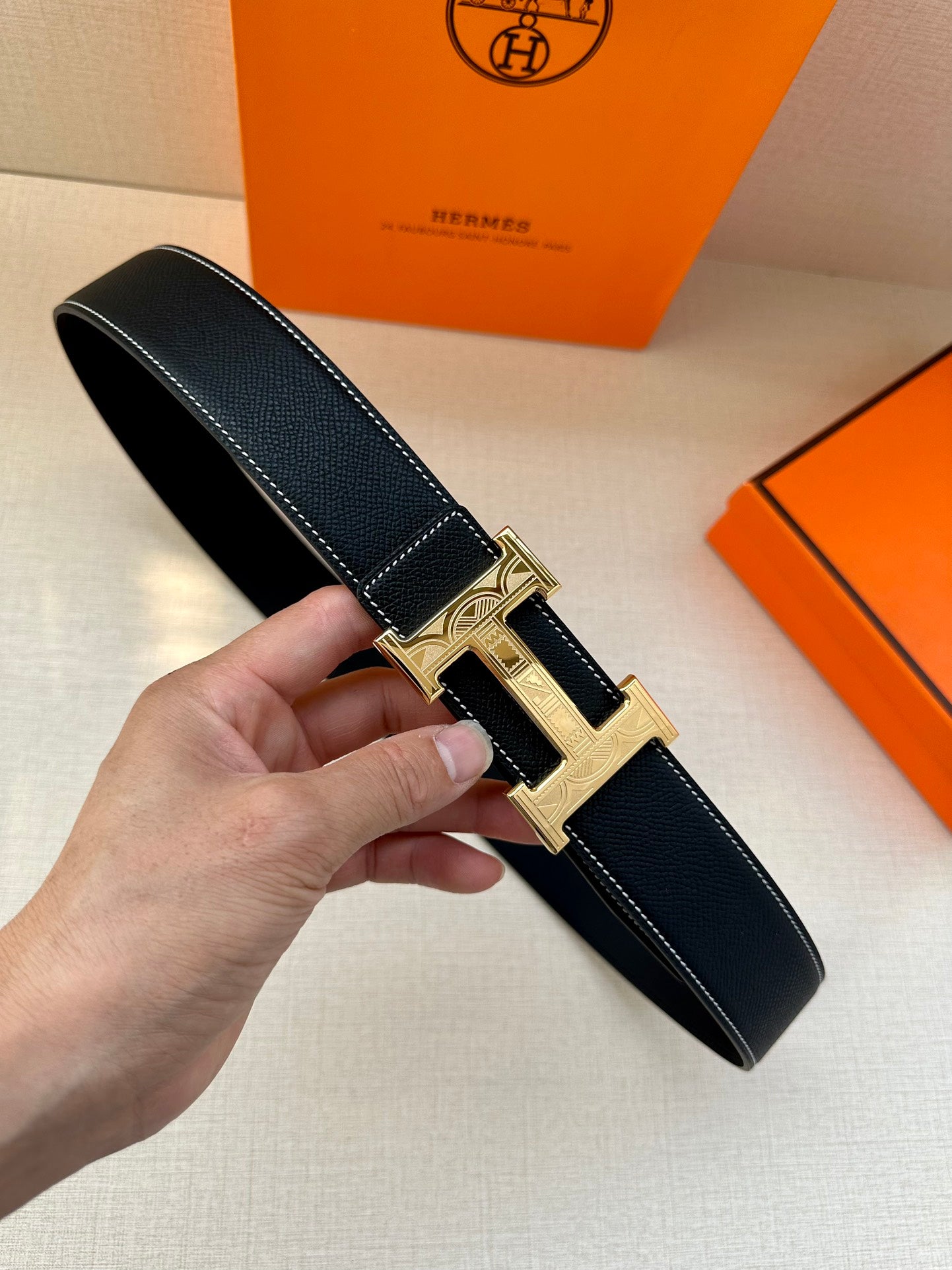 Hermes leather belt, dark navy textured strap, silver H buckle with pin closure