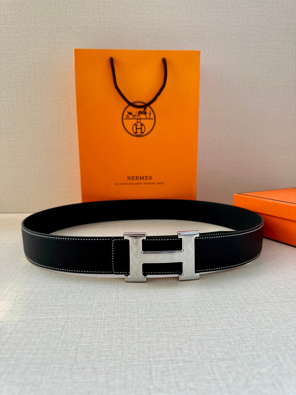 Hermes leather belt, dark navy strap with silver H buckle and polished center bar