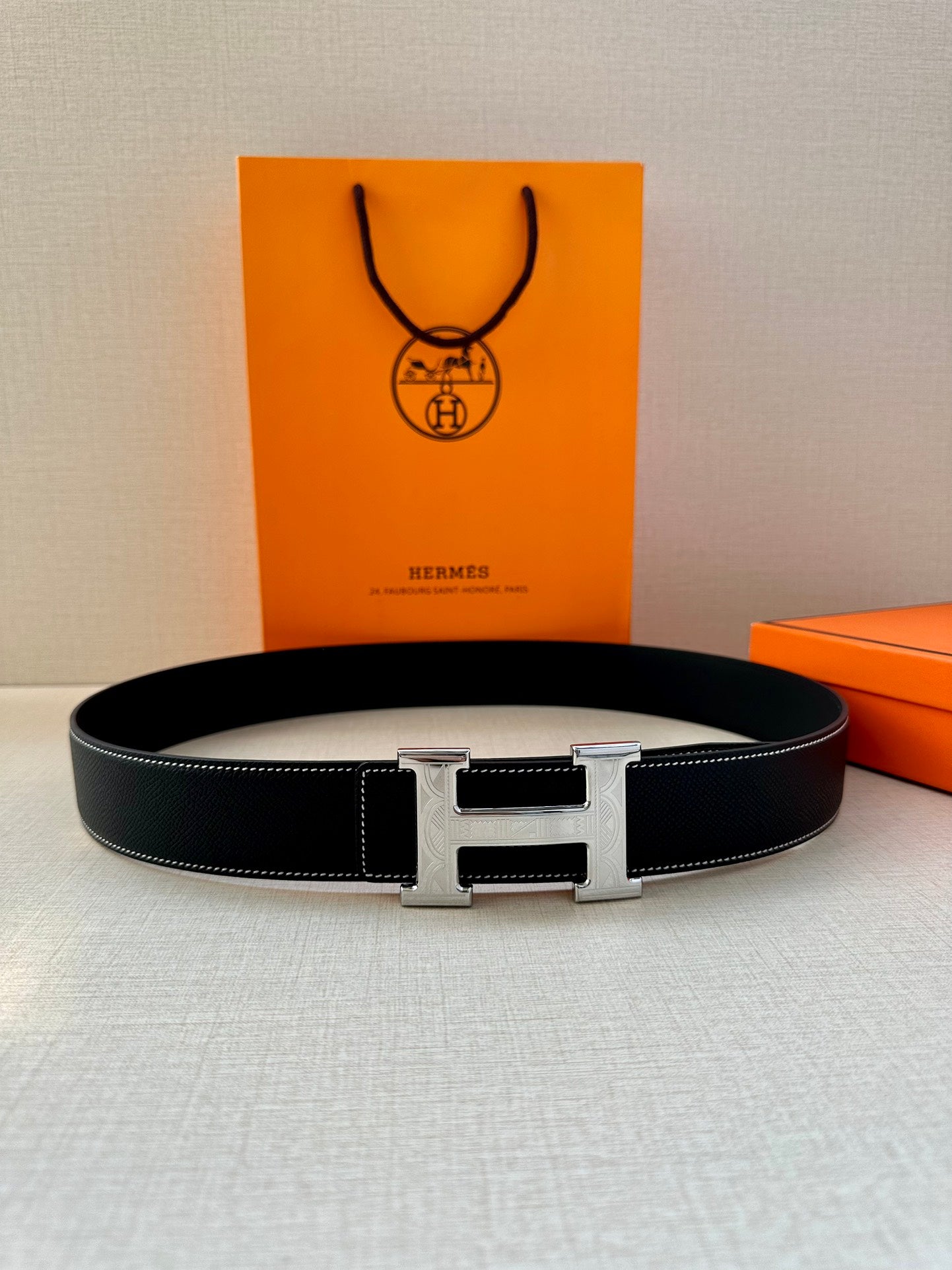 Hermes leather belt, dark navy strap with silver H buckle and polished center bar