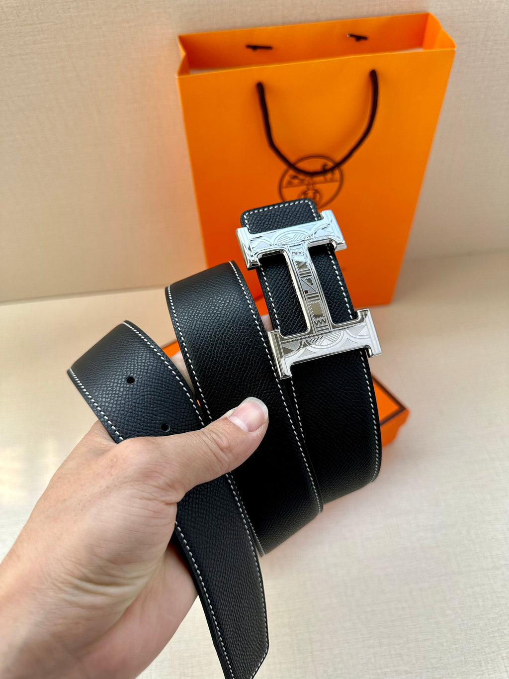 Hermes leather belt, dark navy strap with silver H buckle and embossed stitching