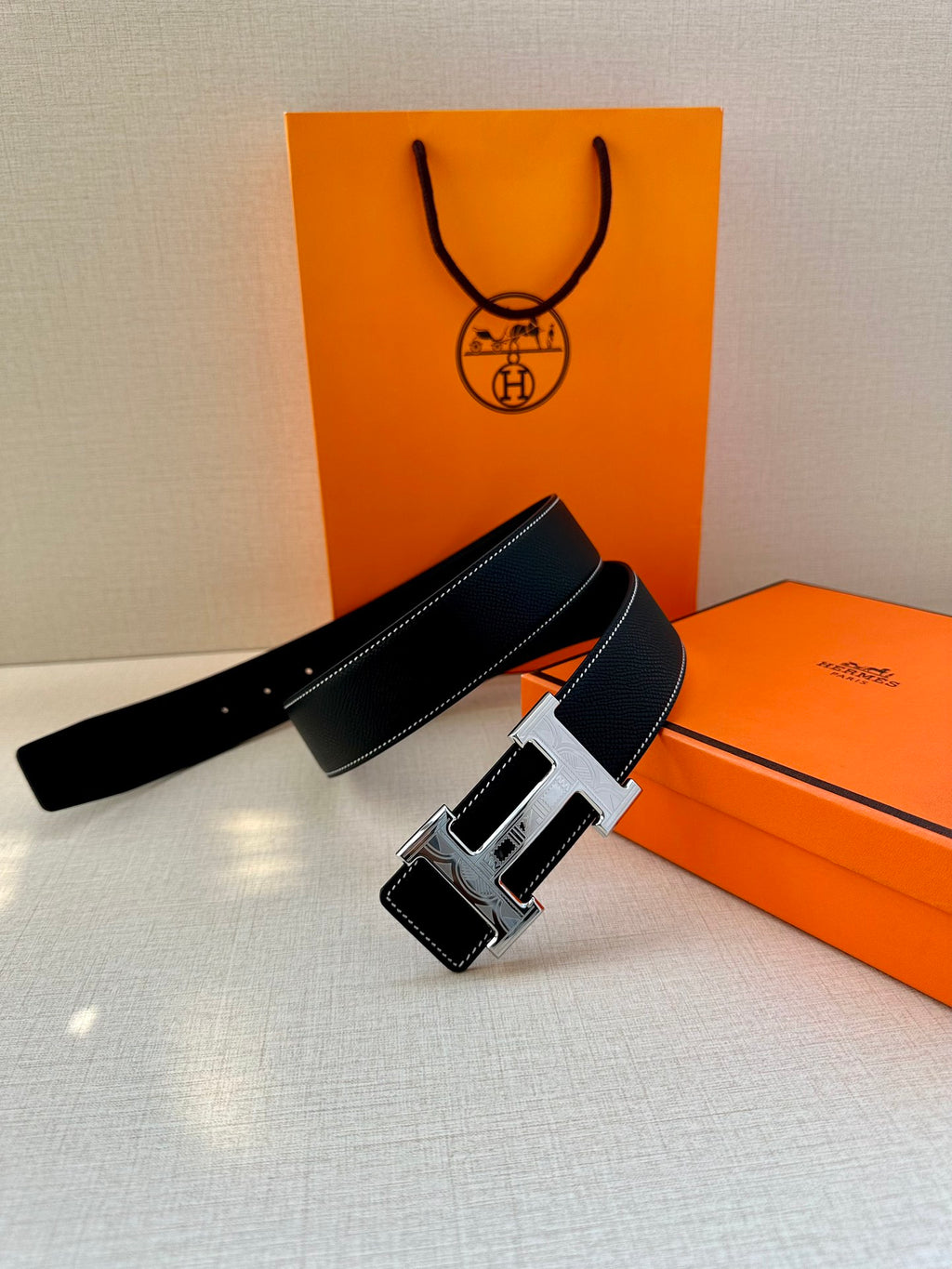 Hermes leather belt, dark navy strap with silver H buckle and wide leather keeper