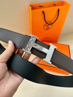 Black leather belt with silver-tone H buckle, belt end and buckle close-up.
