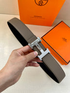 Gray leather belt with silver-tone H buckle and textured finish