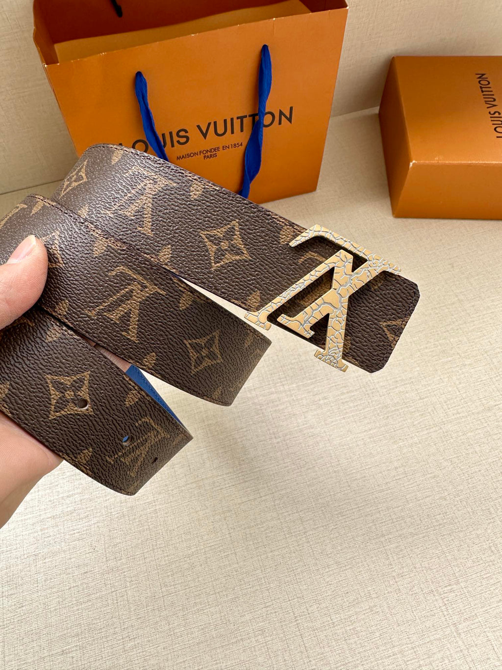 Monogram canvas belt, dark brown with LV buckle and visible adjustment holes