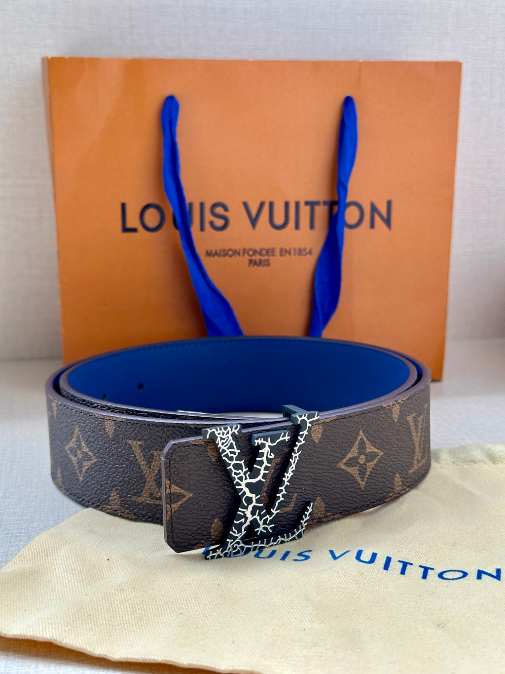 Monogram canvas belt with LV buckle, dark brown strap and blue lining