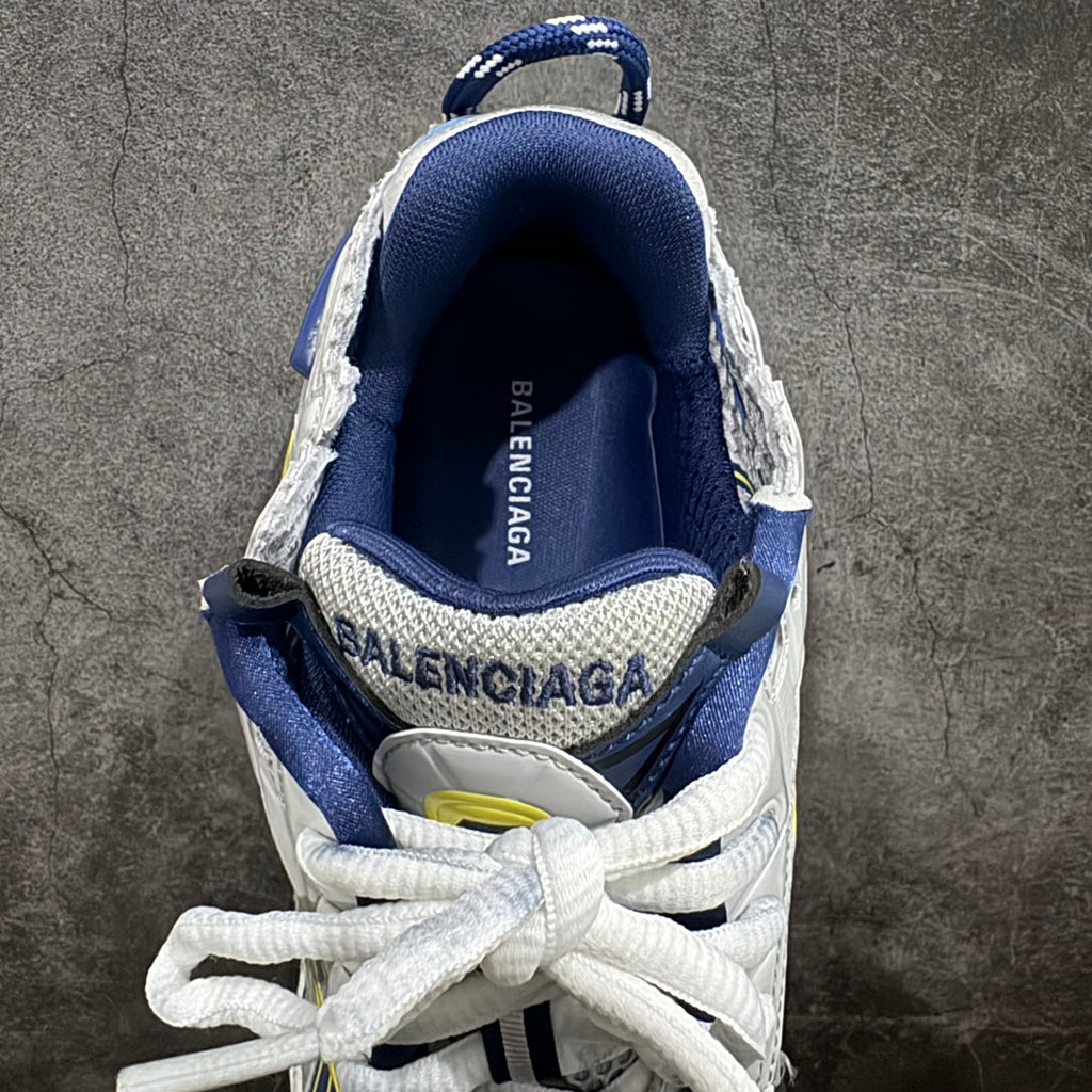 Navy and white sneakers with white laces, rear collar, and logo lettering