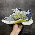 White, blue, and neon yellow lace-up sneakers, side view with ribbed chunky sole