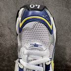 White mesh sneakers with blue trim, lace strap, and rear branding patch
