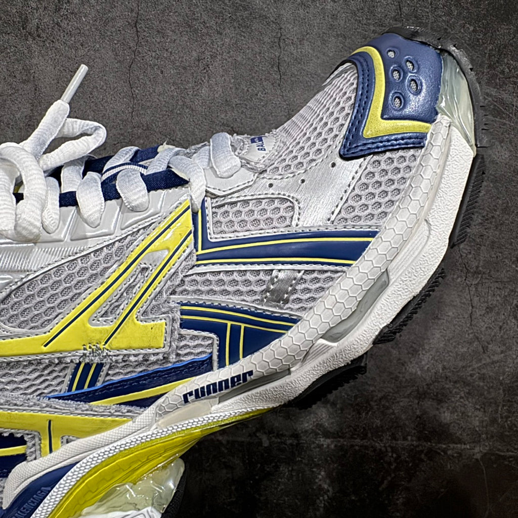 White, blue, and neon yellow sneakers with side logo detail and lace panel
