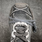 Gray and white sneaker toe area with lace-up fastening and textured knit panels
