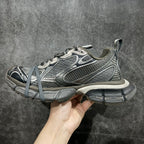 Gray and white lace-up sneaker, side view with textured panels and thick platform sole