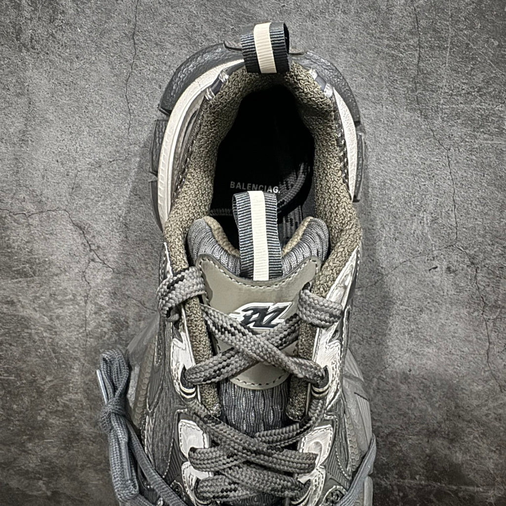 Gray and white sneaker interior and laces visible, with cushioned collar lining