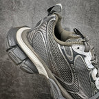 Gray and white mesh lace-up sneaker with swoosh-style logo and molded heel support