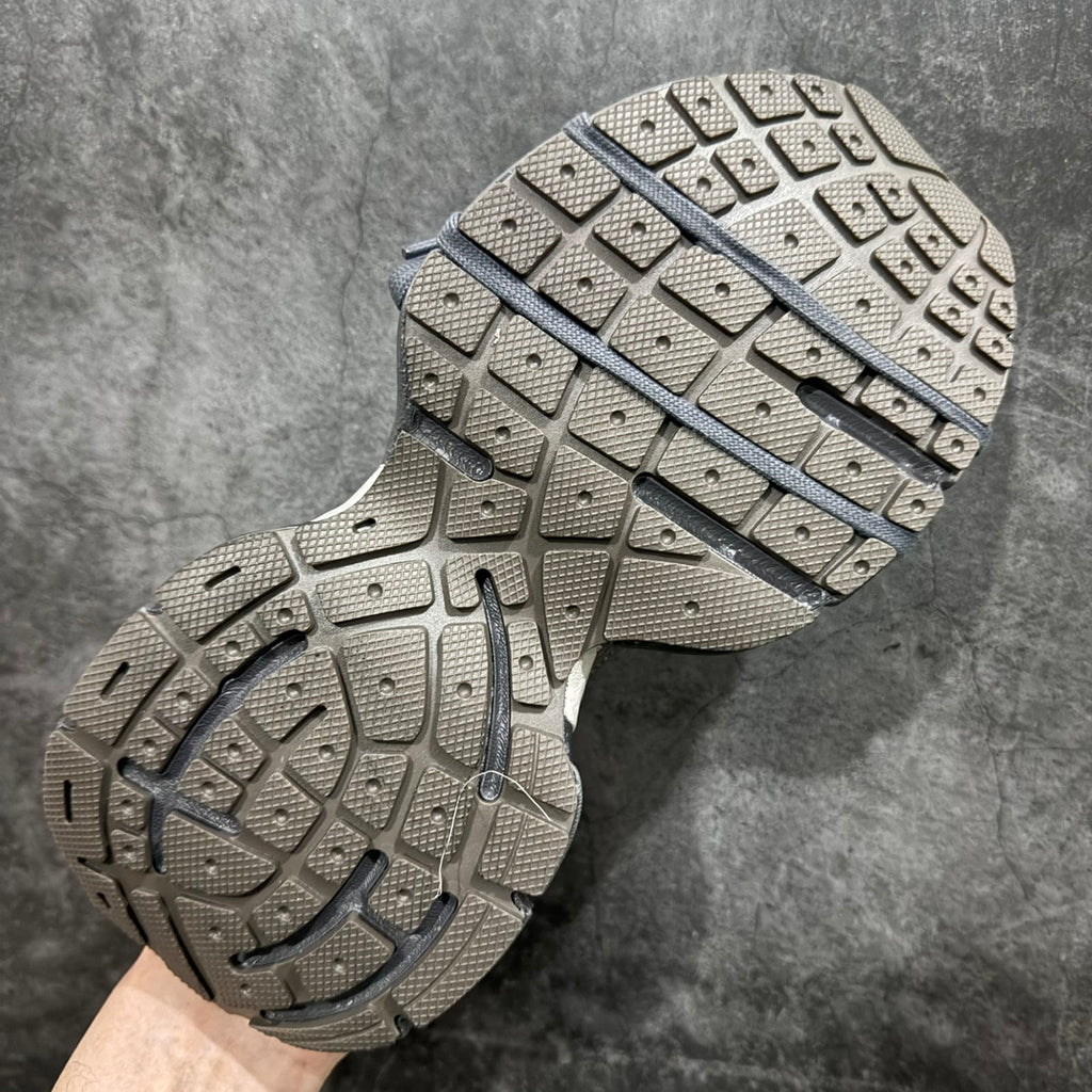Gray sneaker outsole with rubber tread and blue stripe accent across midfoot