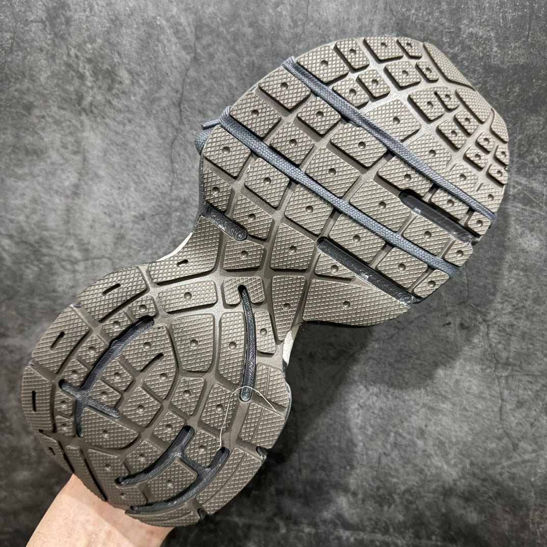 Gray sneaker outsole with rubber tread and blue stripe accent across midfoot