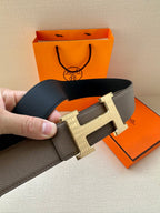 Gray leather belt with silver-tone H buckle, close-up angled view