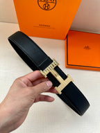 Black leather belt with silver-tone H buckle in textured metal