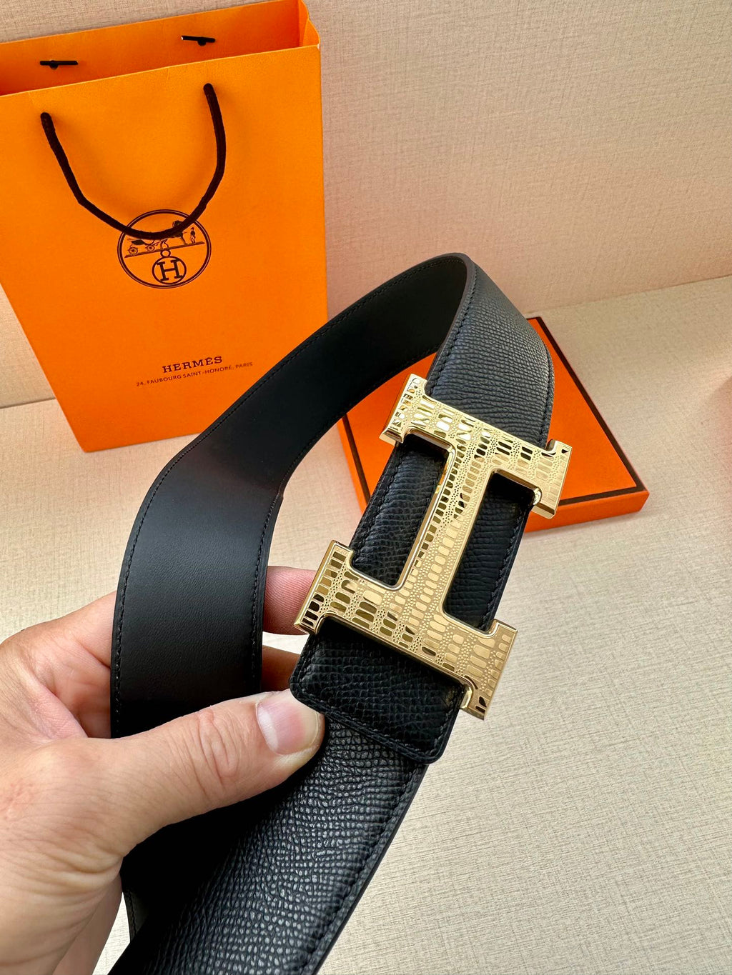 Black leather belt with wide silver-tone buckle, front view