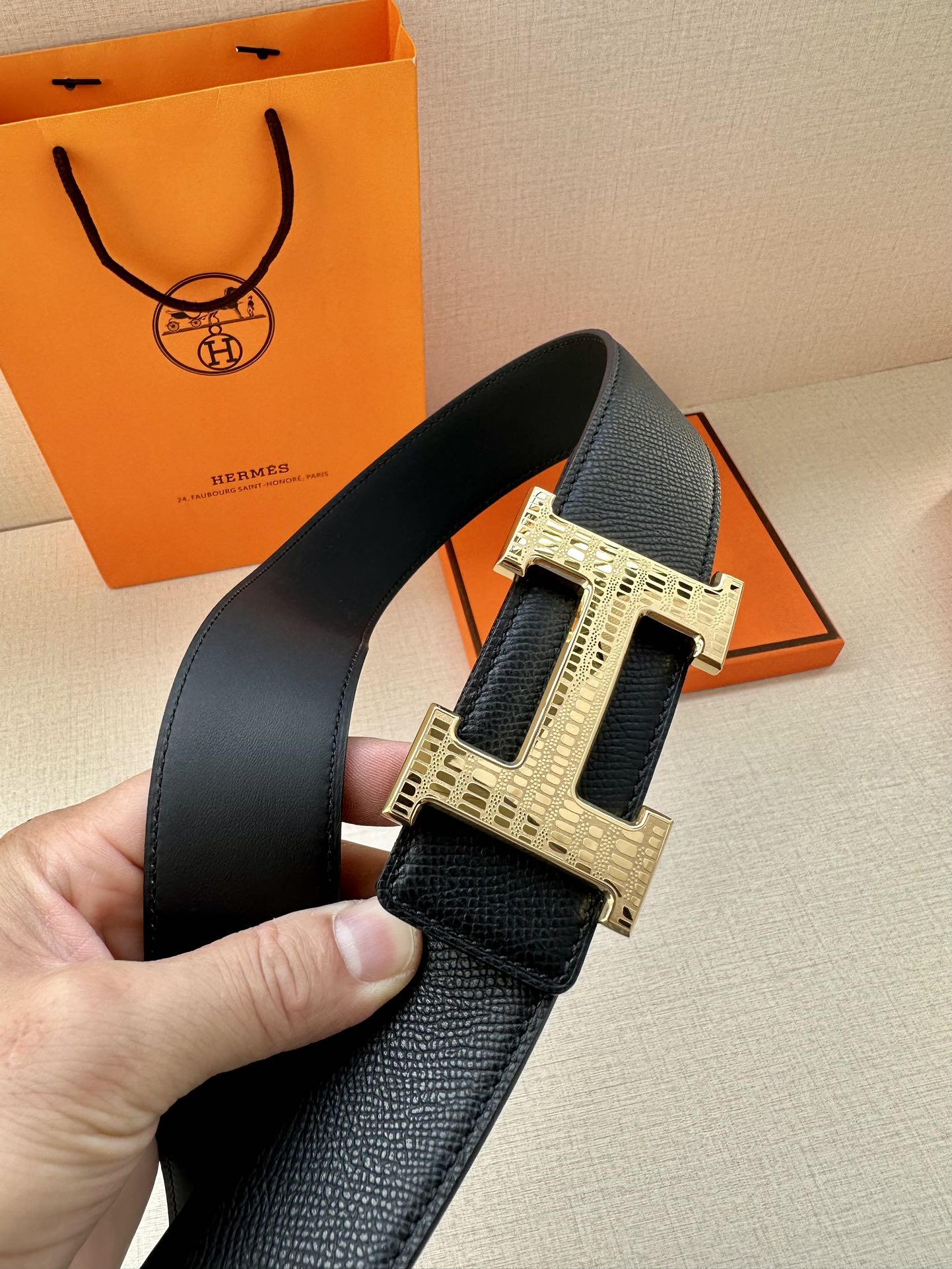 Black leather belt with wide silver-tone buckle, front view