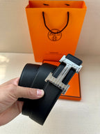 Black leather belt with silver-tone H buckle and keeper strap