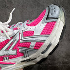 Pink and white unisex sneaker upper close-up with mesh panels and silver side detail