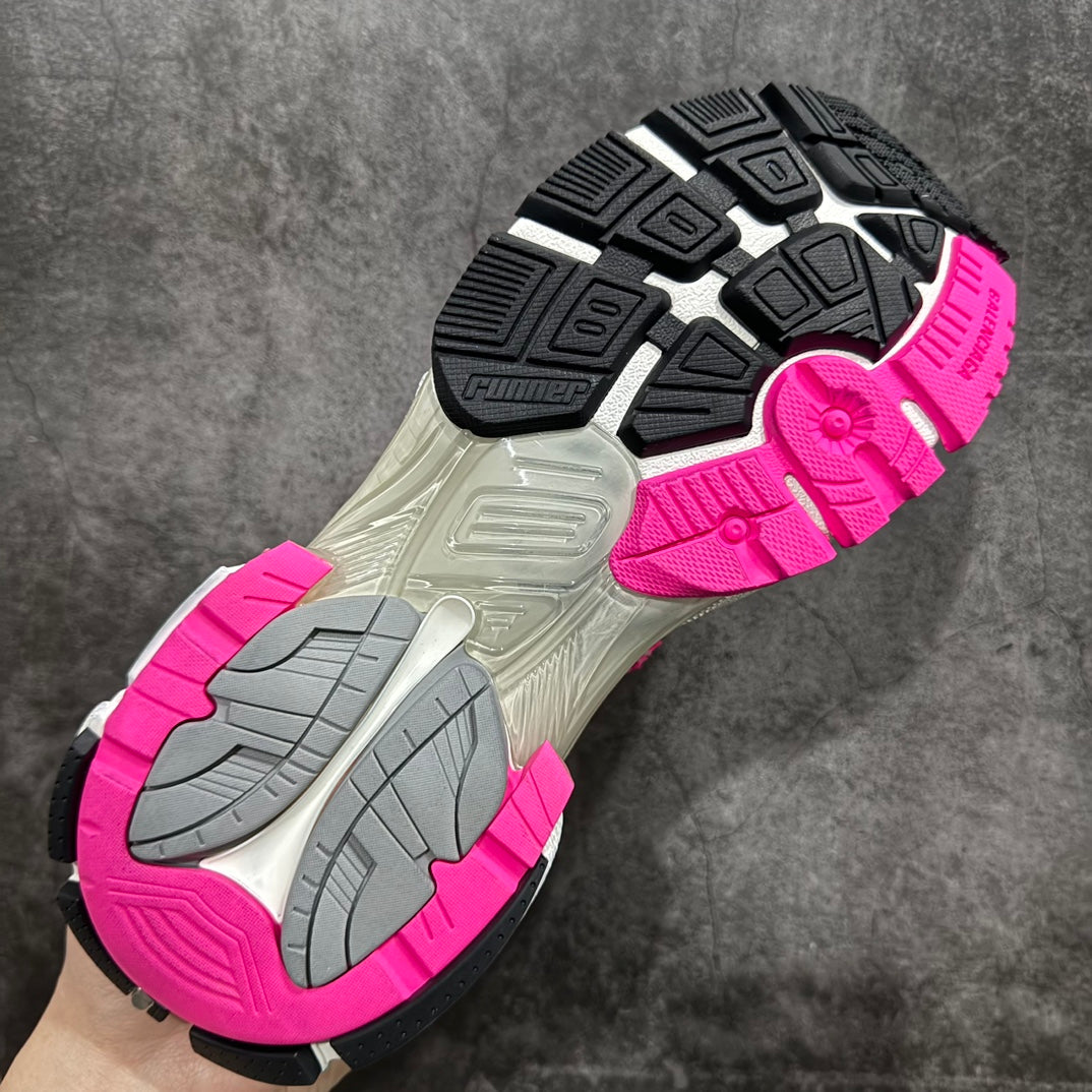 Unisex sneaker outsole with dark tread pattern and bright pink edge trim