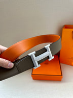 Leather belt with textured dark gray strap and silver-tone square H buckle.