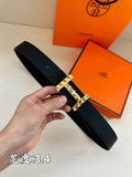 Black leather belt with textured silver-tone H buckle and prong closure.