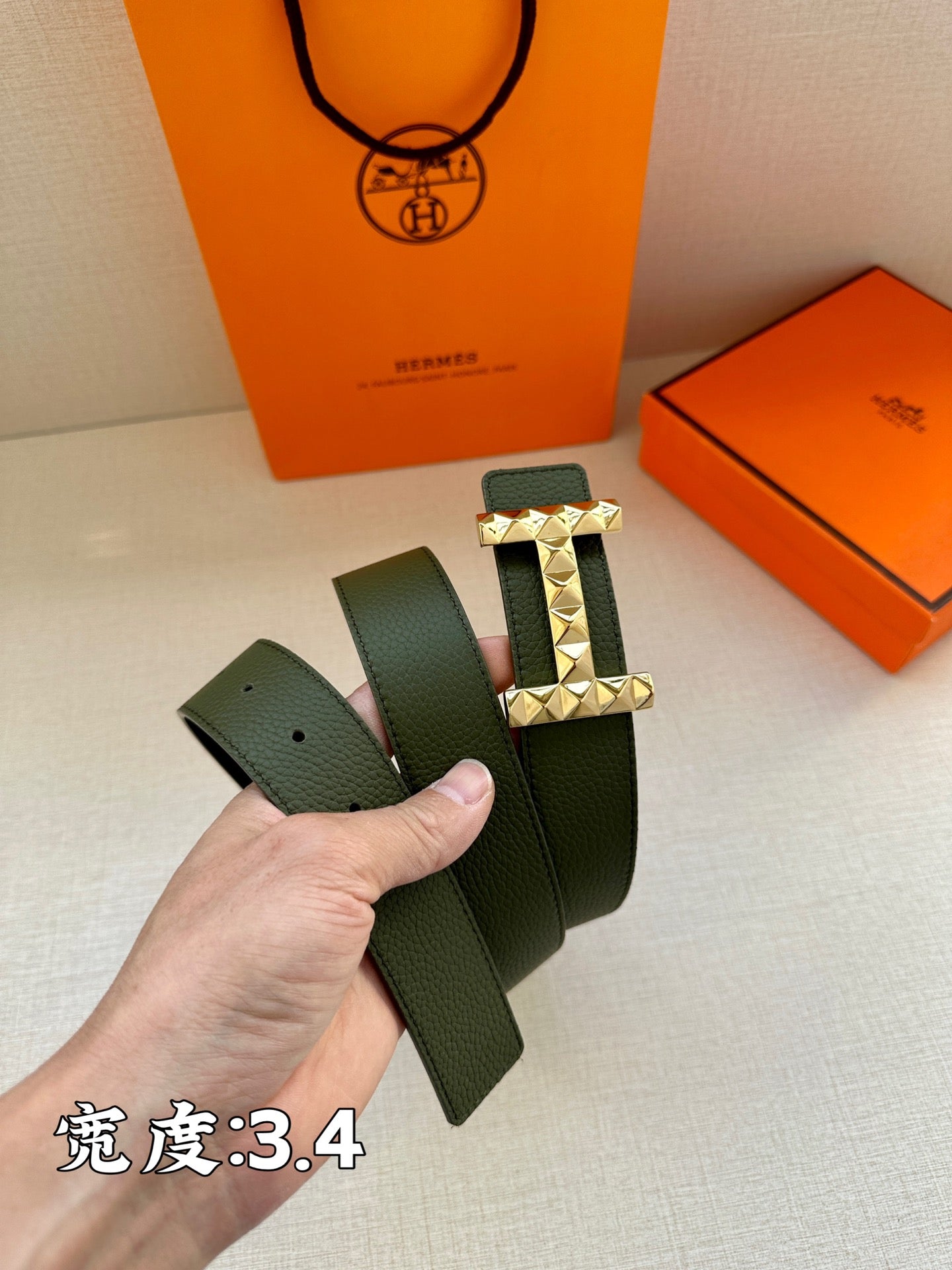 Hermes belt dark green leather with silver-tone studded H buckle, showing end and holes