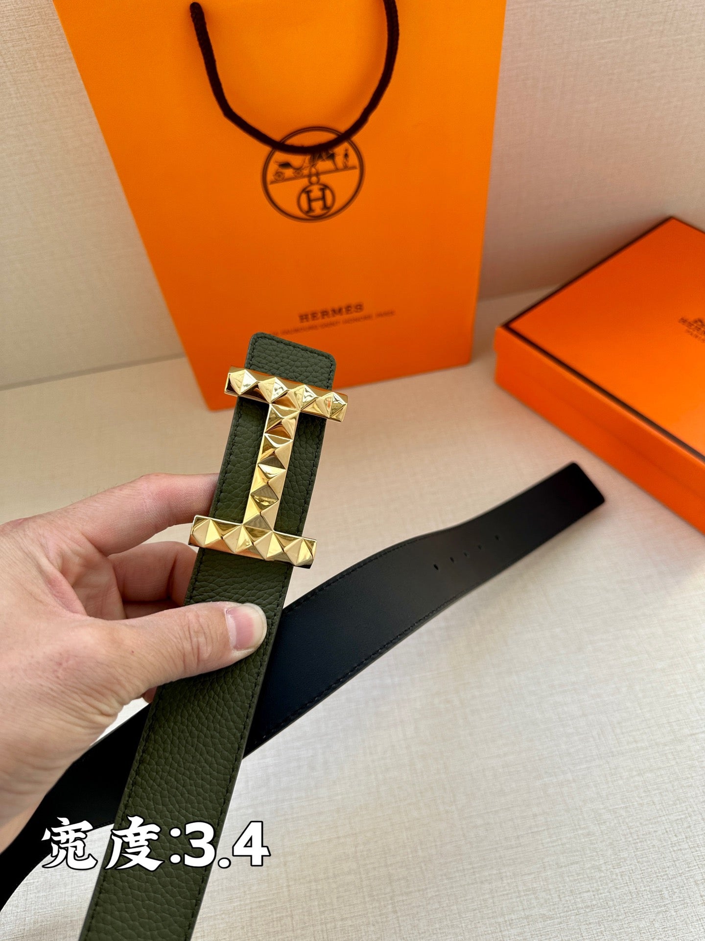 Hermes belt dark green leather with silver-tone studded buckle and visible strap edge