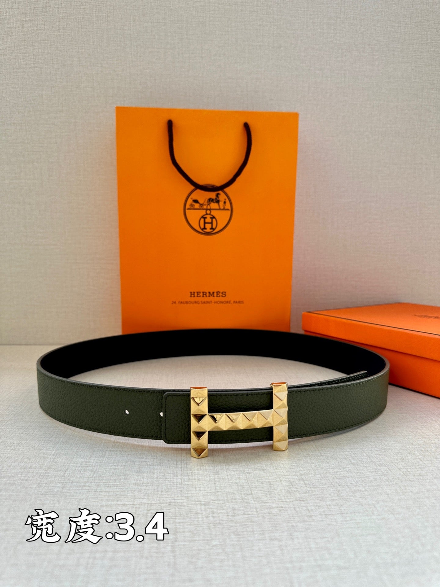 Hermes belt dark green leather with silver-tone studded H buckle, side view