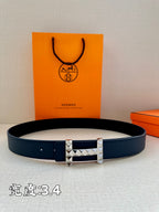 Dark blue leather belt with silver studded buckle on display