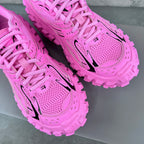 Balenciaga unisex sneakers close-up: bright pink laces, perforated panels, black logo