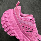 Pink sneaker outsole and side lacing, thick tread with geometric blocks