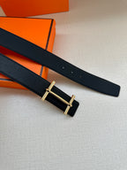 Black leather belt with gold buckle frame and two strap holes