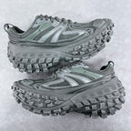 Balenciaga unisex trail shoes with chunky lug soles and lace-up mesh uppers, muted green.