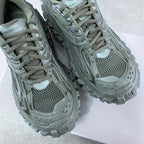 Balenciaga unisex trail shoes with lace-up mesh uppers and textured overlays, muted green.