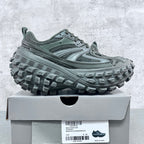 Balenciaga unisex lace-up trail shoes with deep lug outsoles, muted green.