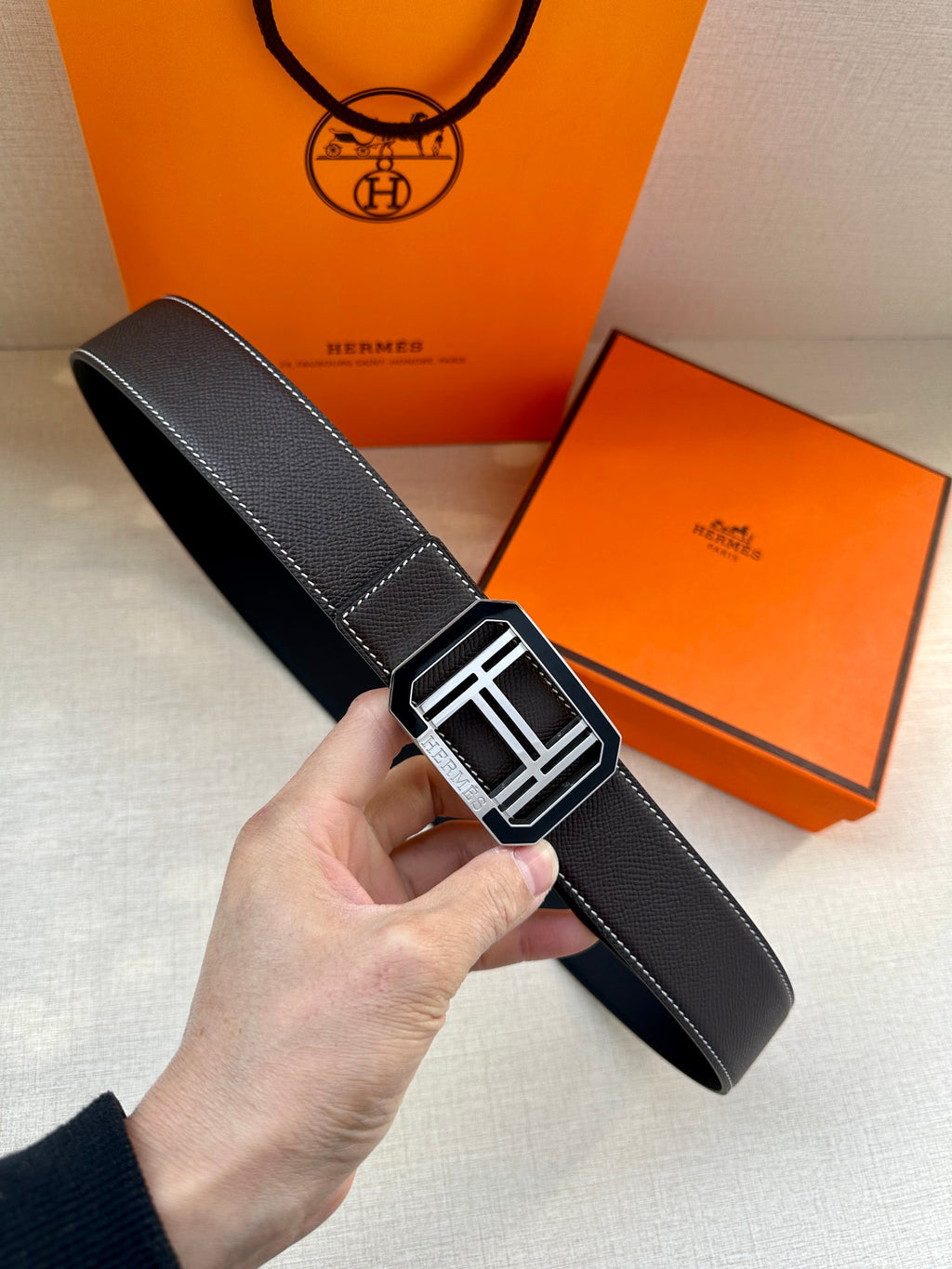 Black leather belt with textured finish and silver-tone rectangular buckle