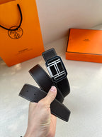 Black leather belt with silver-tone rectangular buckle and cut end