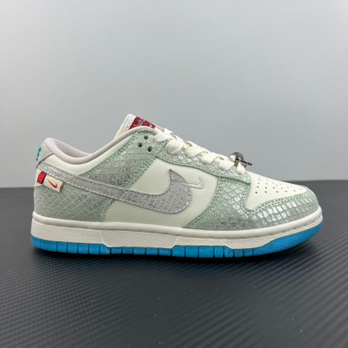 Seafoam and white low-top sneakers with blue outsole, side Nike swoosh, and white laces