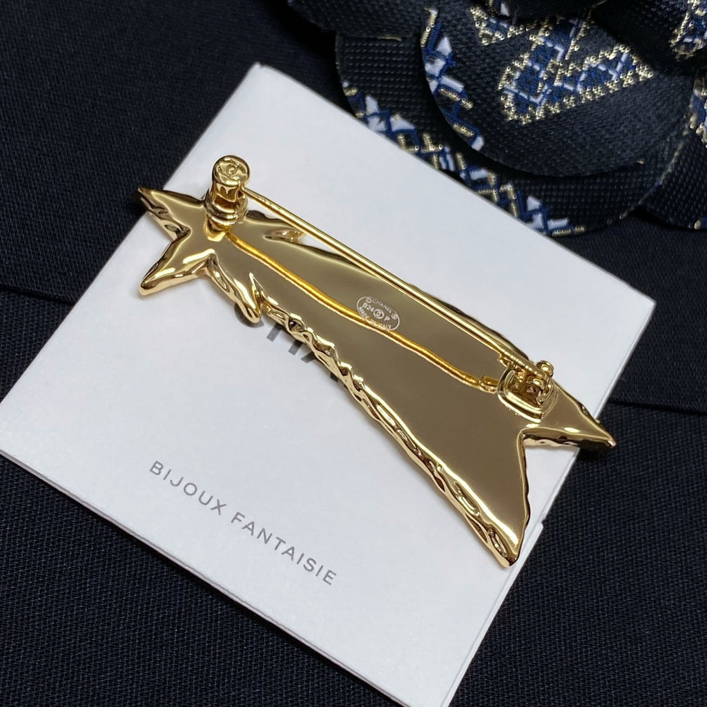 Gold-tone abstract bar brooch with star ends on Bijoux Fantaisie card