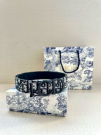 Dior belt with black-and-blue logo pattern strap and dark round buckle