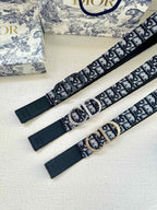 Dior belt laid flat with logo webbing, dark buckle, and leather end tabs
